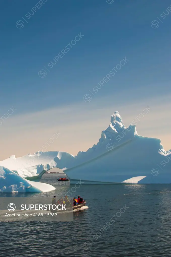 Antarctica, Antarctic Peninsula,  Iceberg With Arch At Palmer Station (United States Research Station), Tourists In Zodiac