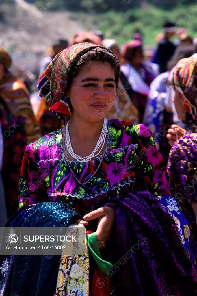 Uzbekistan, Bukhara, Market Scene, Gypsy Woman Selling Fabrics