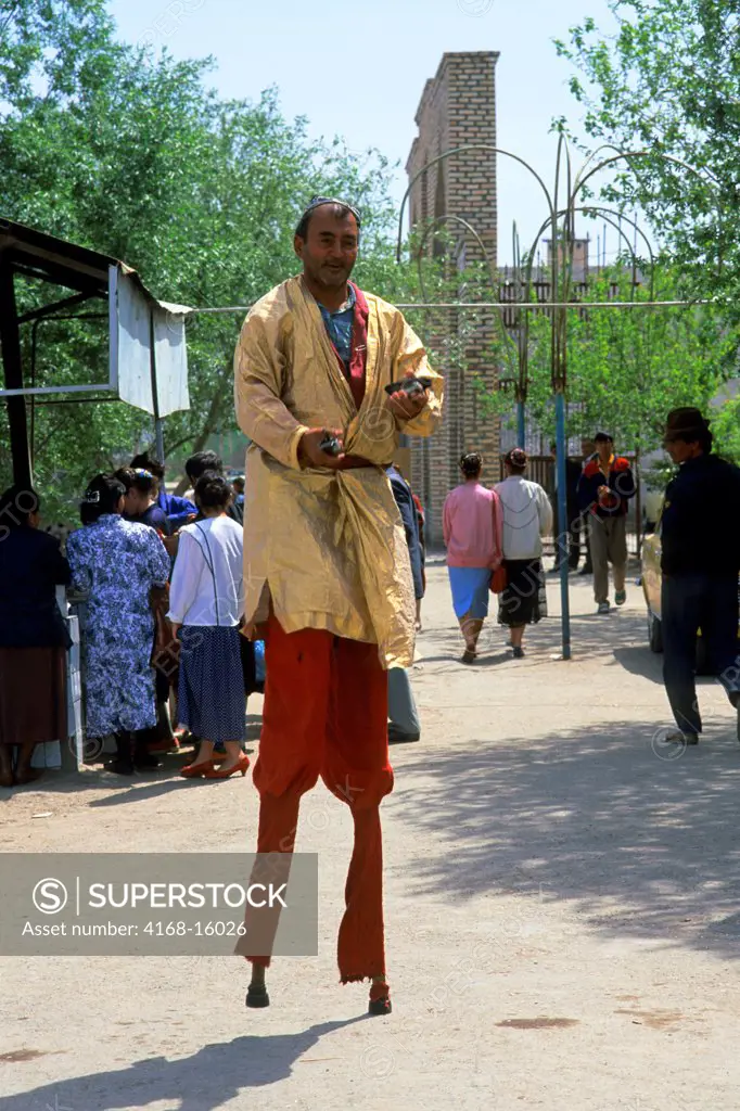 Uzbekistan, Urganch, Market Scene, Men On Stilts