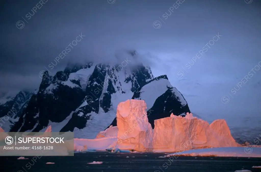 ANTARCTIC PENINSULA, ARGENTINE ISLANDS, ICEBERGS REFLECTING SUNSET