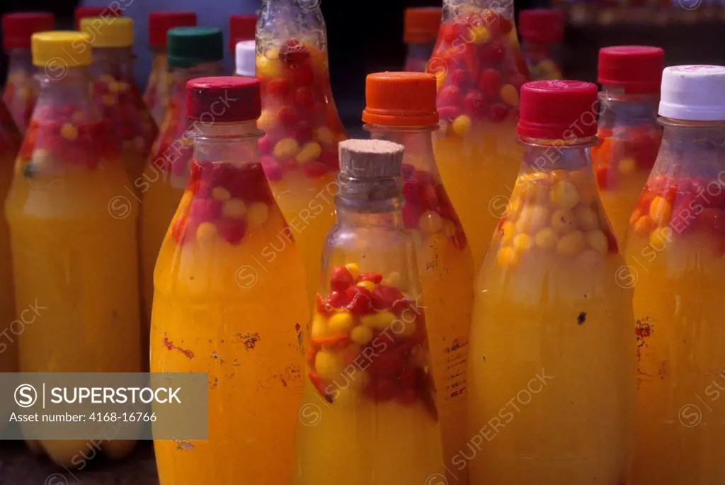 On A Market In Santarem, A City Along The Amazon River In Brazil, Colorful Bottles With Hot Sauce Are For Sale