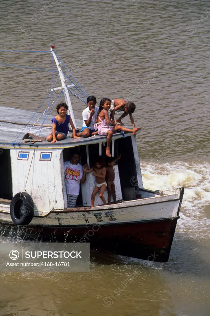 A Small Boat With People Navigates Through The Narrows Of The Amazon River Delta Near Belem, Brazil