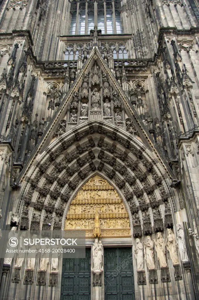 Architectural detail of the stone carvings above the front door of the Cologne cathedral in Cologne, Nordrhein-Westfalen, Germany.