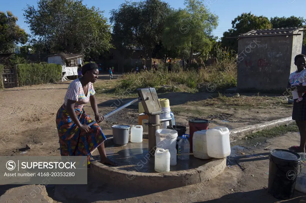 People getting water from a well in a small village near Livingston in Zambia.