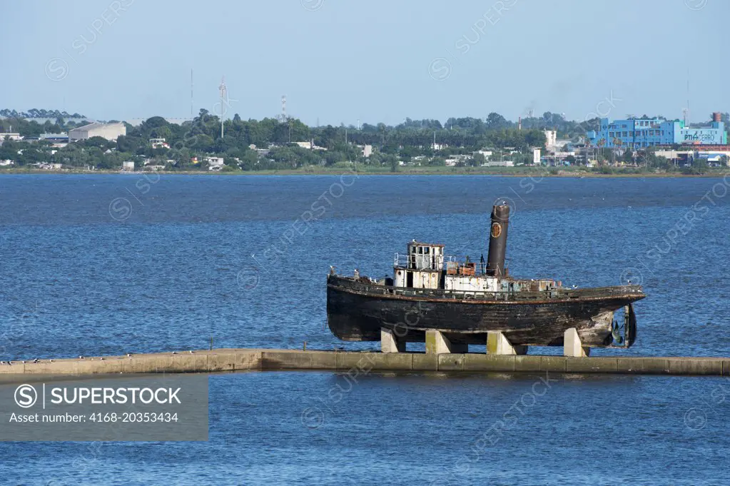 Old wooden ship at the entrance of the Montevideo port in Uruguay.