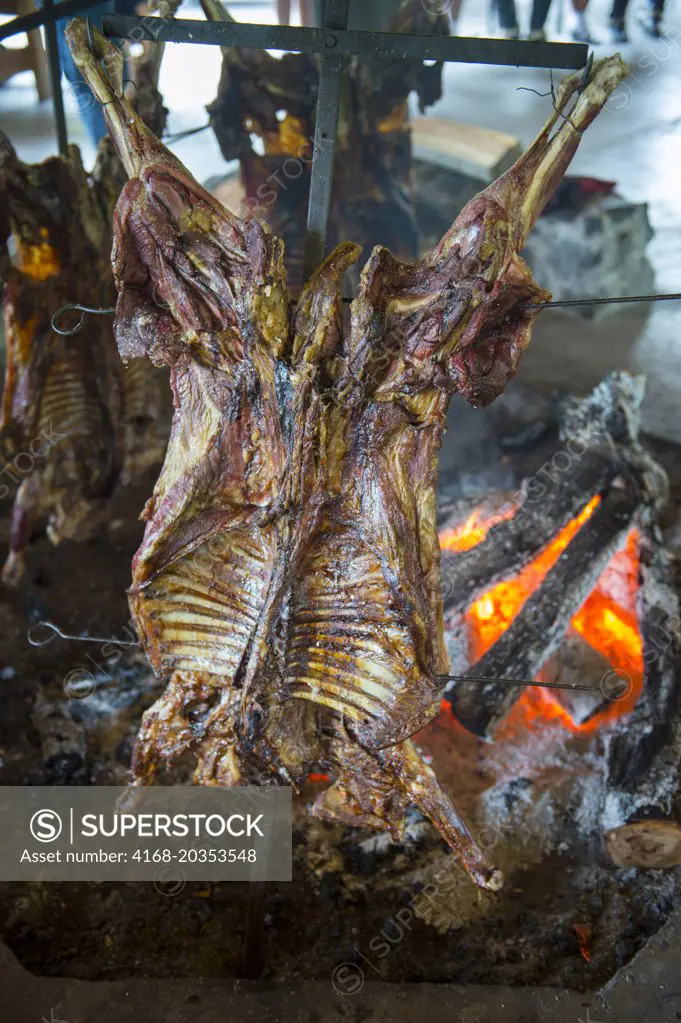 Asado (traditional lamb barbecue) in Puerto Chacabuco in the Chilean Fjords in southern Chile.