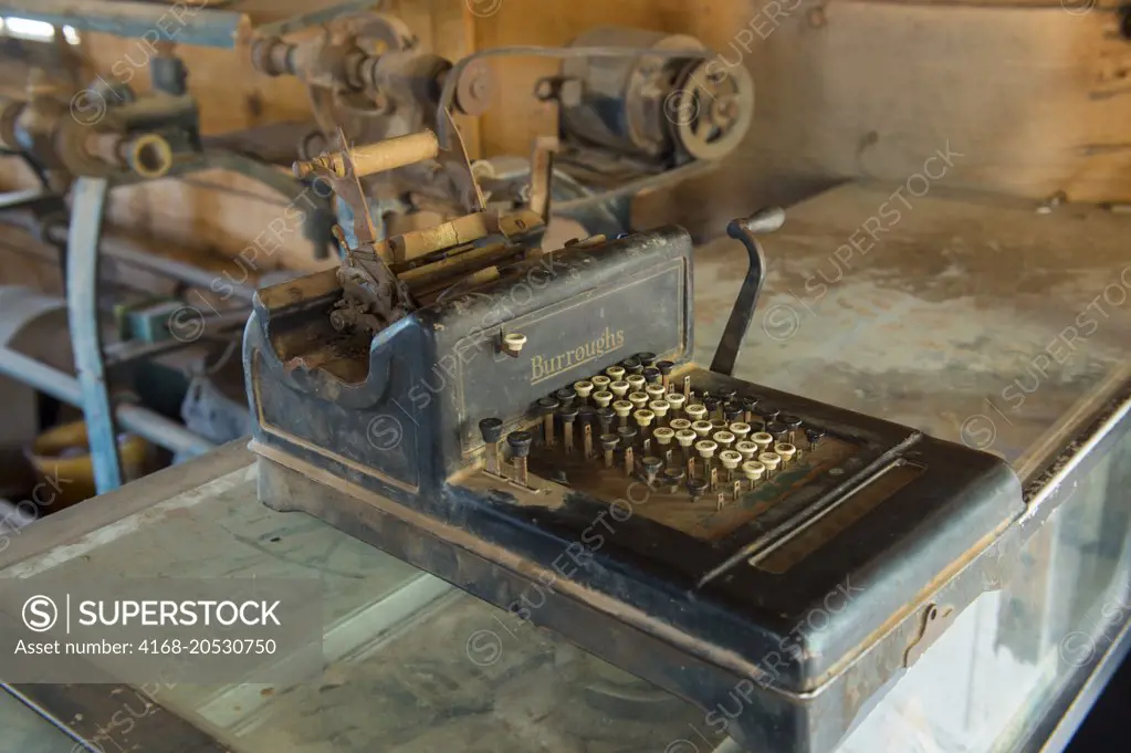 The interior of a shoemaker shop with an old calculator at the historic Gold King Mine and Ghost Town from the 1890s outside of Jerome in Arizona, USA.