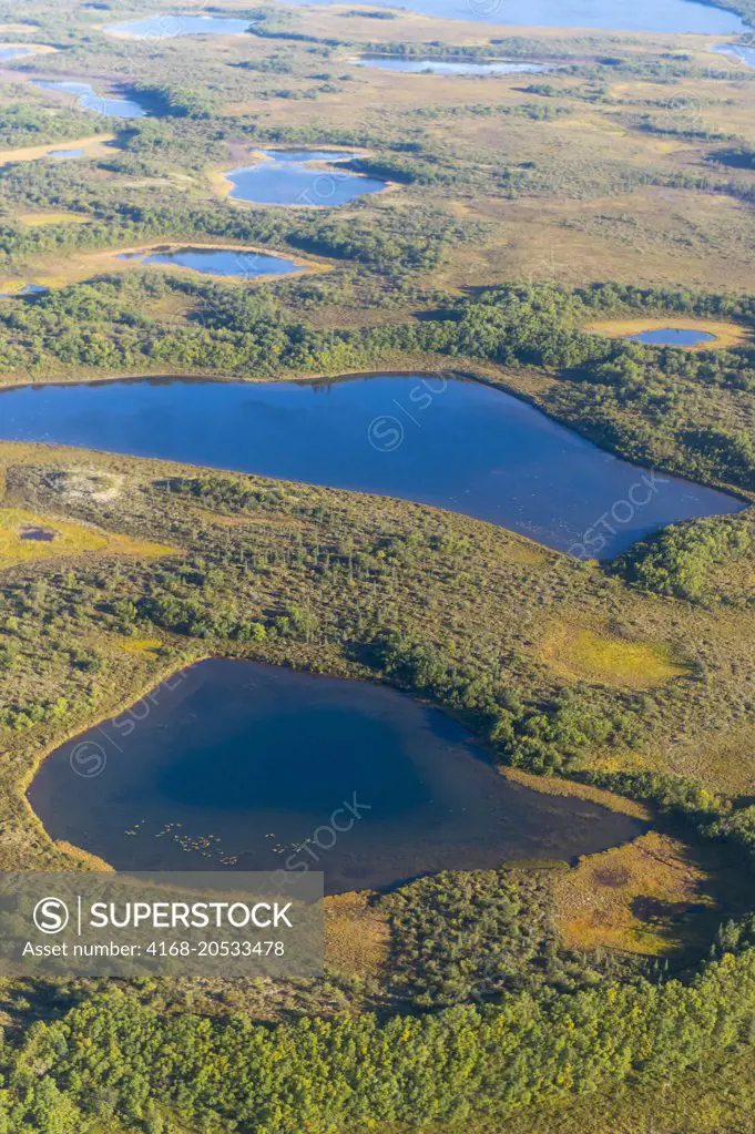 View of the tundra with lakes and muskeg during the flight by seaplane from King Salmon on the Katmai Peninsula in Alaska, USA to Brooks Lake in Katmai National Park and Preserve.