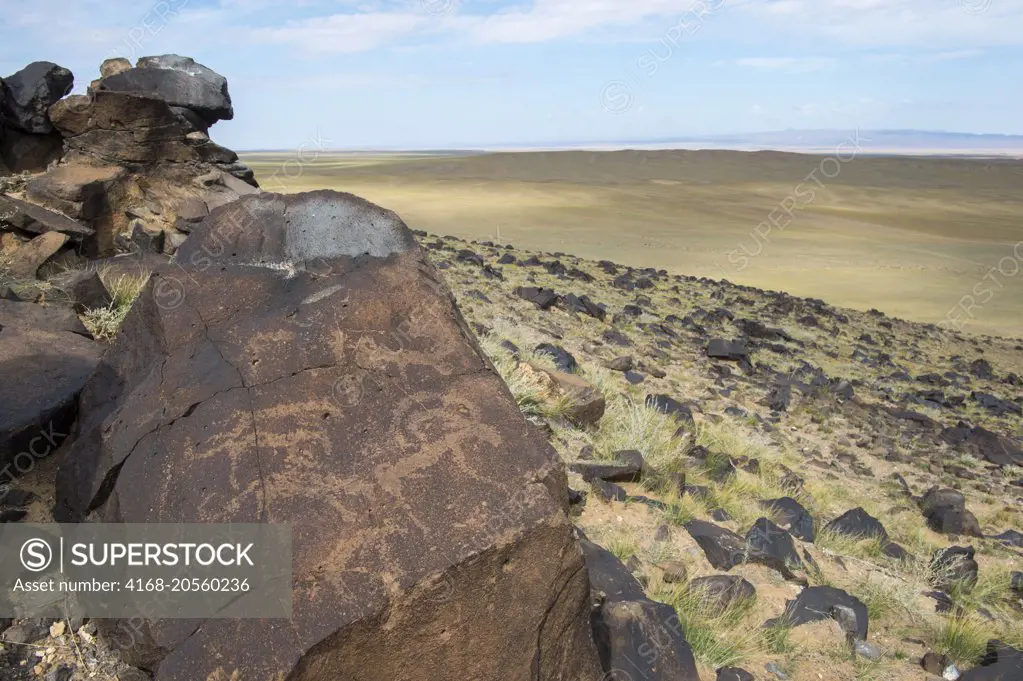 Several thousand year old petroglyphs of animals including ibex on a rock in the Black Mountains in the Gobi Desert near Bulgan in southern Mongolia.