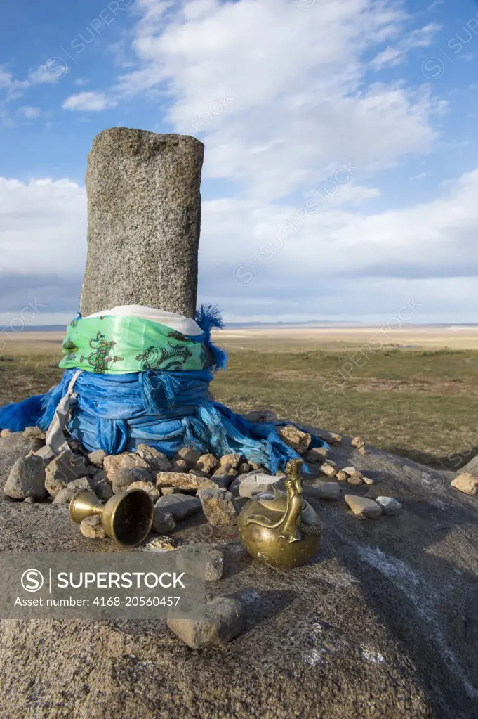 Close-up of the offerings on top of a stone tortoise on a hill above the Erdene Zuu monastery (UNESCO World Heritage Site) in Kharakhorum (Karakorum), Mongolia.