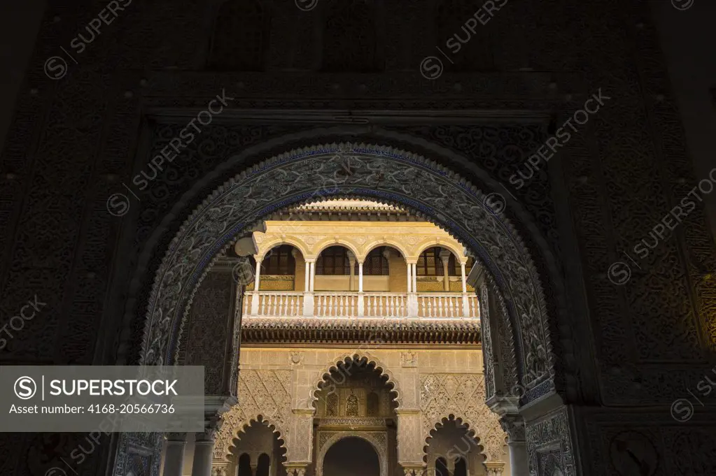 The Patio de las Doncellas, the main courtyard of the palace of King Pedro in the Alcazar, a royal palace, originally a Moorish fort in Seville, Andalusia, Spain.