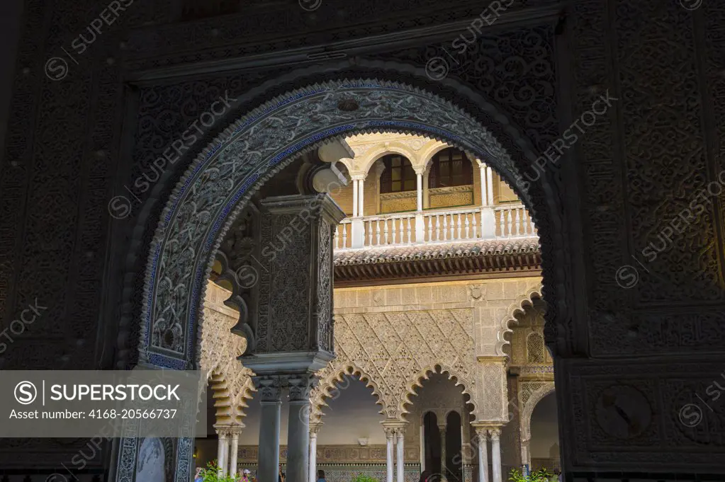 The Patio de las Doncellas, the main courtyard of the palace of King Pedro in the Alcazar, a royal palace, originally a Moorish fort in Seville, Andalusia, Spain.