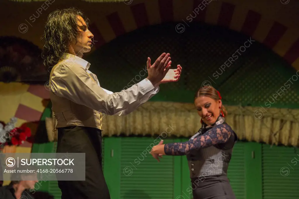 Dancers and musicians performing the Flamenco, a form of Spanish folk music and dance, during a dinner show in Seville, Andalusia, Spain.