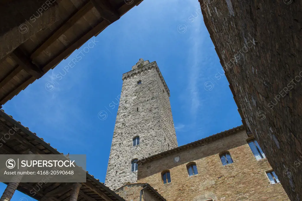 Street scene with towers in the medieval walled hill town of San Gimignano in Tuscany, Italy.