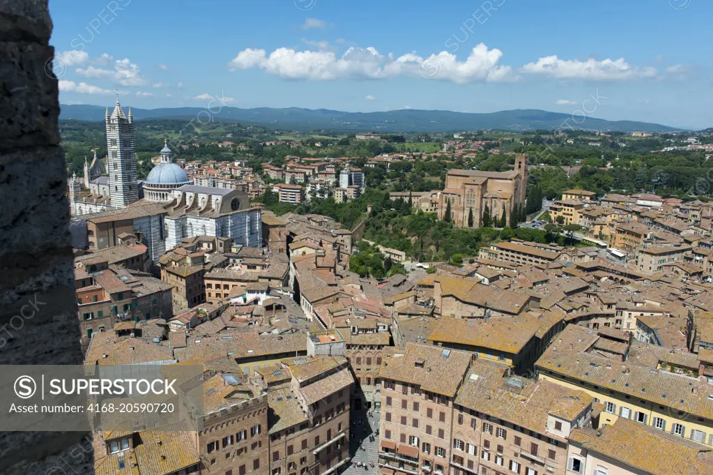 View of the city of Siena with the Siena Cathedral from the Mangia Tower (Torre del Mangia), built in 1338-1348, Tuscany, central Italy.