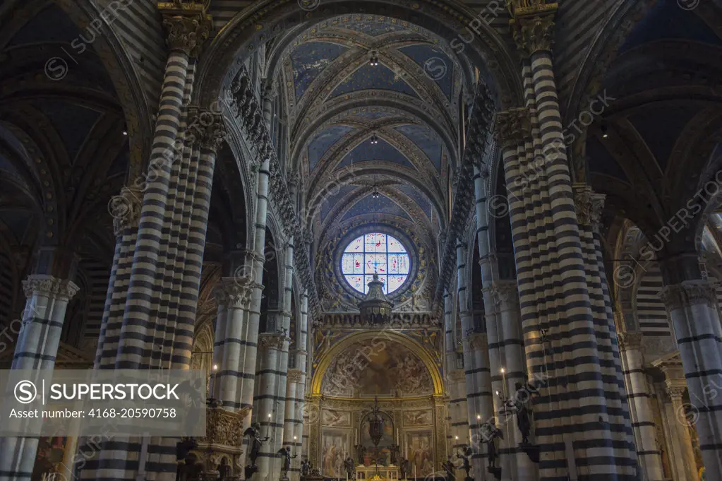 Interior with the rose window of the Siena Cathedral di Santa Maria, better known as the Duomo, in Siena, Tuscany, Italy.