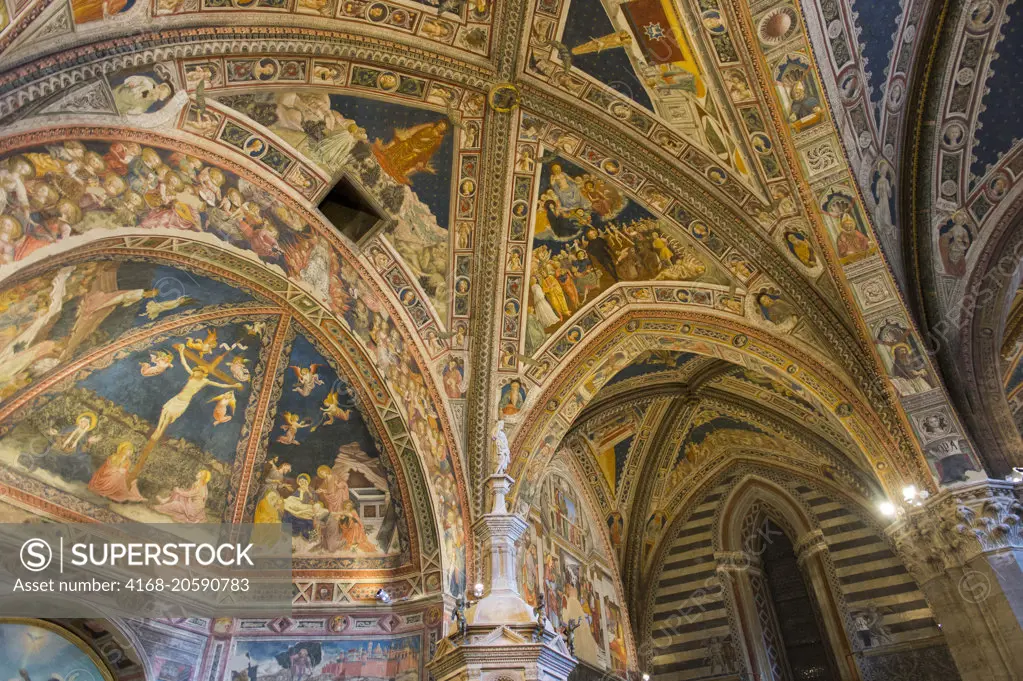 The colorful painted ceiling in the Siena Cathedral Baptistery in Siena, Tuscany, Italy.