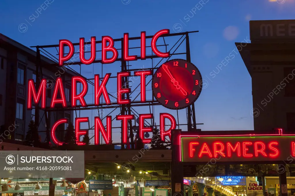 A night photo of the neon sign over the main entrance to the Pike Place Market in Seattle, Washington State, USA.