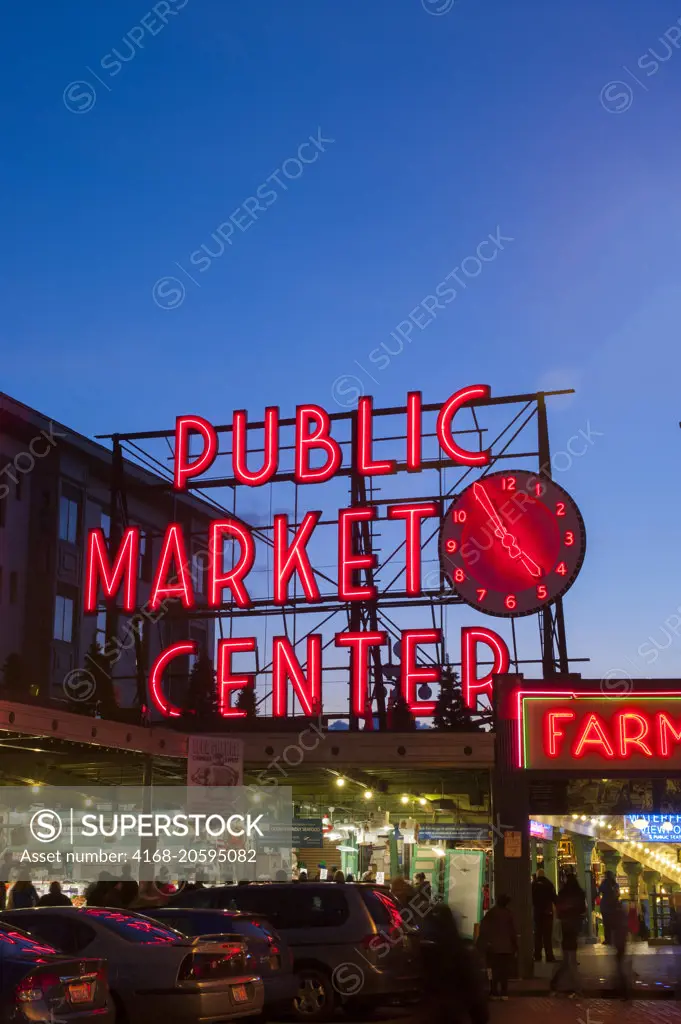 A night photo of the neon sign over the main entrance to the Pike Place Market in Seattle, Washington State, USA.