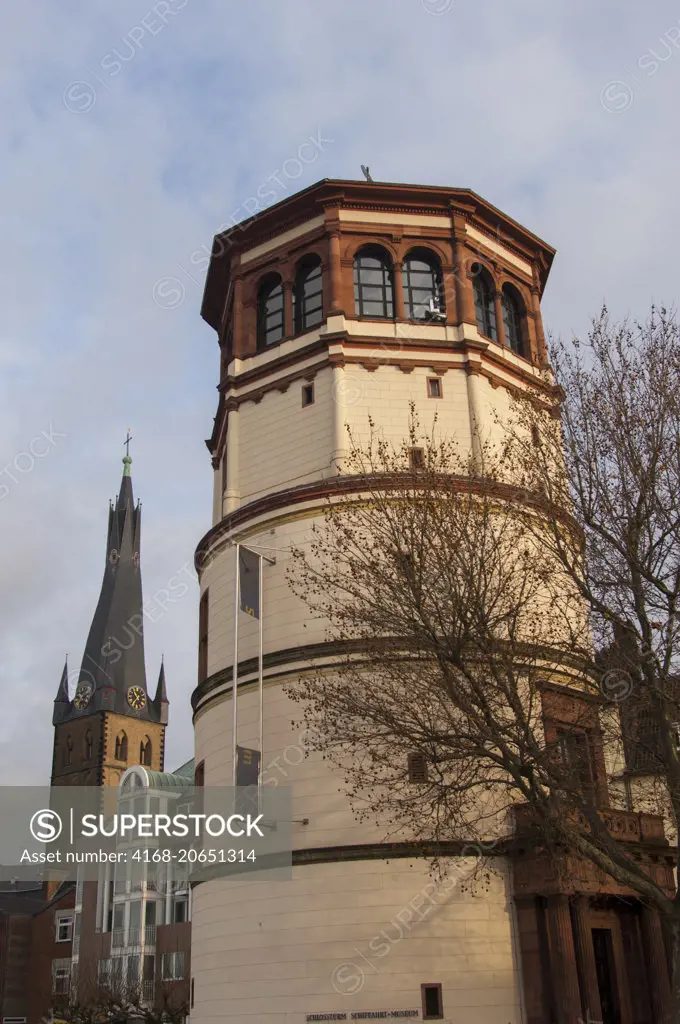 View of the old Schlossturm (palace tower) on the Rhine River embankment houses one of the oldest German inland shipping museums in the old town of Dusseldorf, Germany.