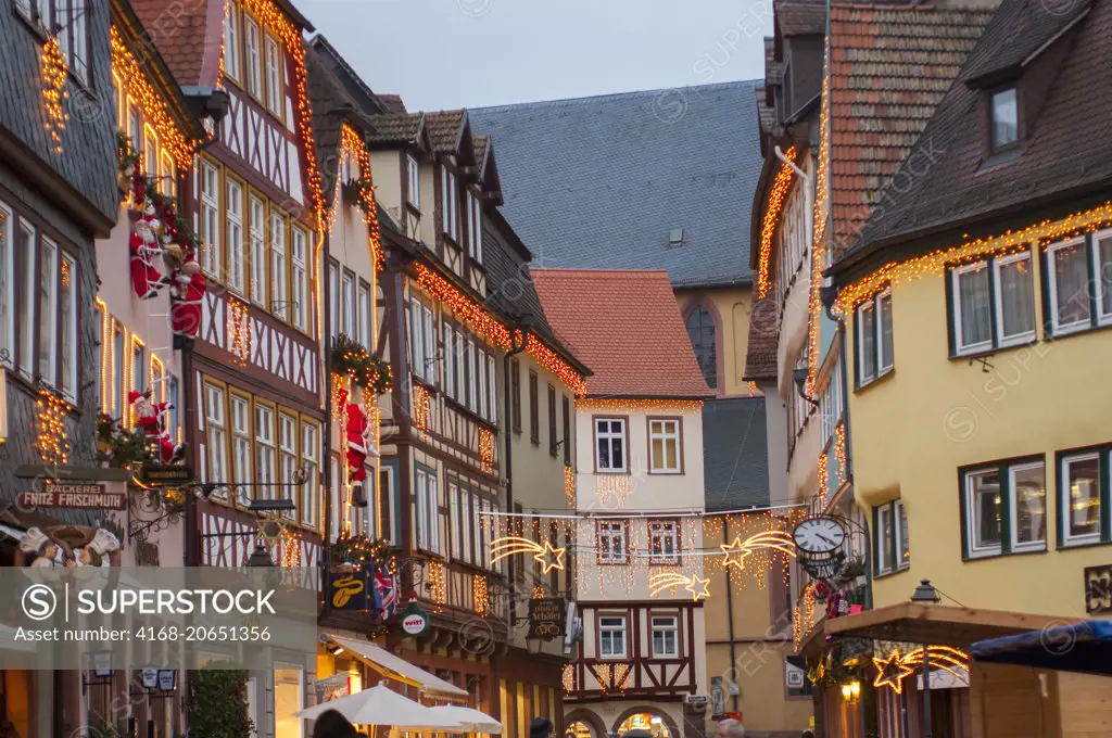 Street scene with half-timbered houses with Christmas decorations at the market square in the small town of Wertheim in Baden-Wurttemberg in Germany.