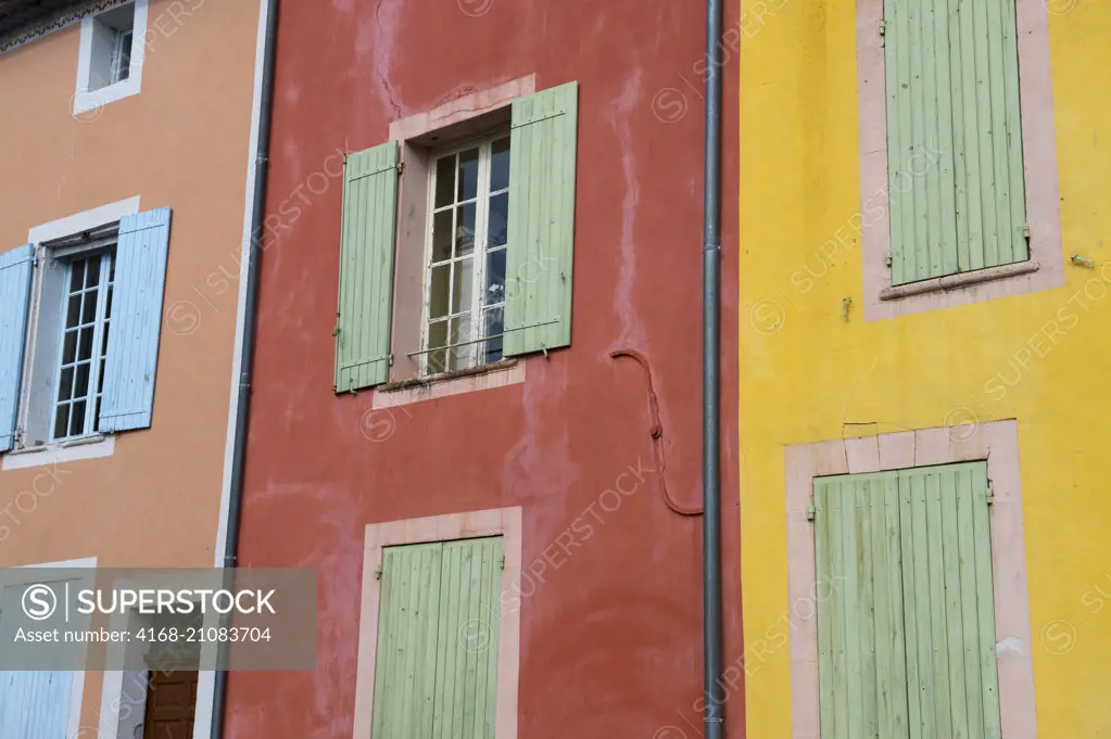 Detail of colorful houses in the village of Roussillon in the Luberon, Provence-Alpes-Côte d'Azur region in southeastern France.