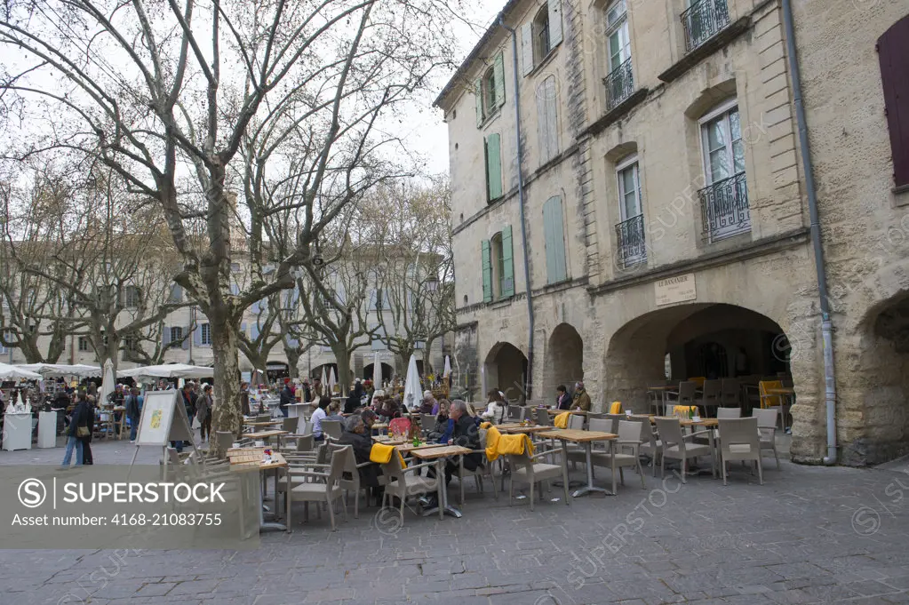 Street scene on the town square in the old town of Uzes, a small town in the Gard department in southern France.