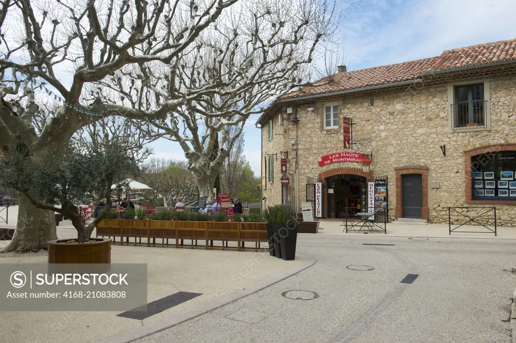 A street scene with the restaurant Du verre l'assiette in Gigondas, a medieval village in the Vaucluse department of the Provence-Alpes-Côte d'Azur region in southeastern France.