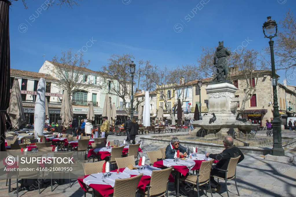 The Saint-Louis square with a statue of Saint-Louis in the center of the fortified city of Aigues-Mortes in the Languedoc-Roussillon region of southern France.