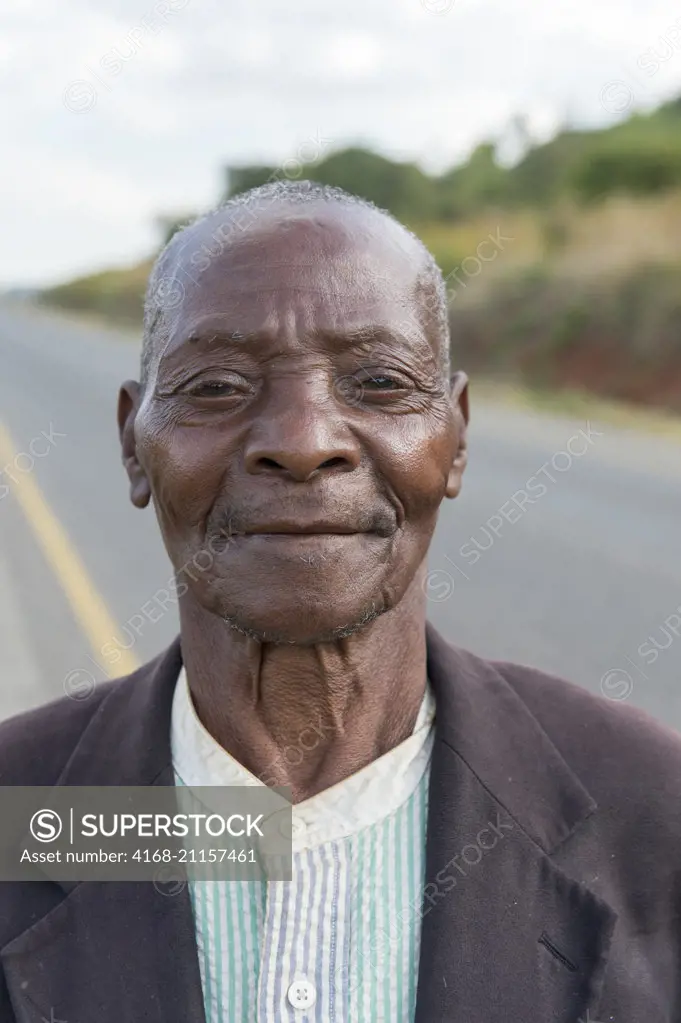 Portrait of a Malawian man walking along the road from Blantyre to Zomba in Malawi.
