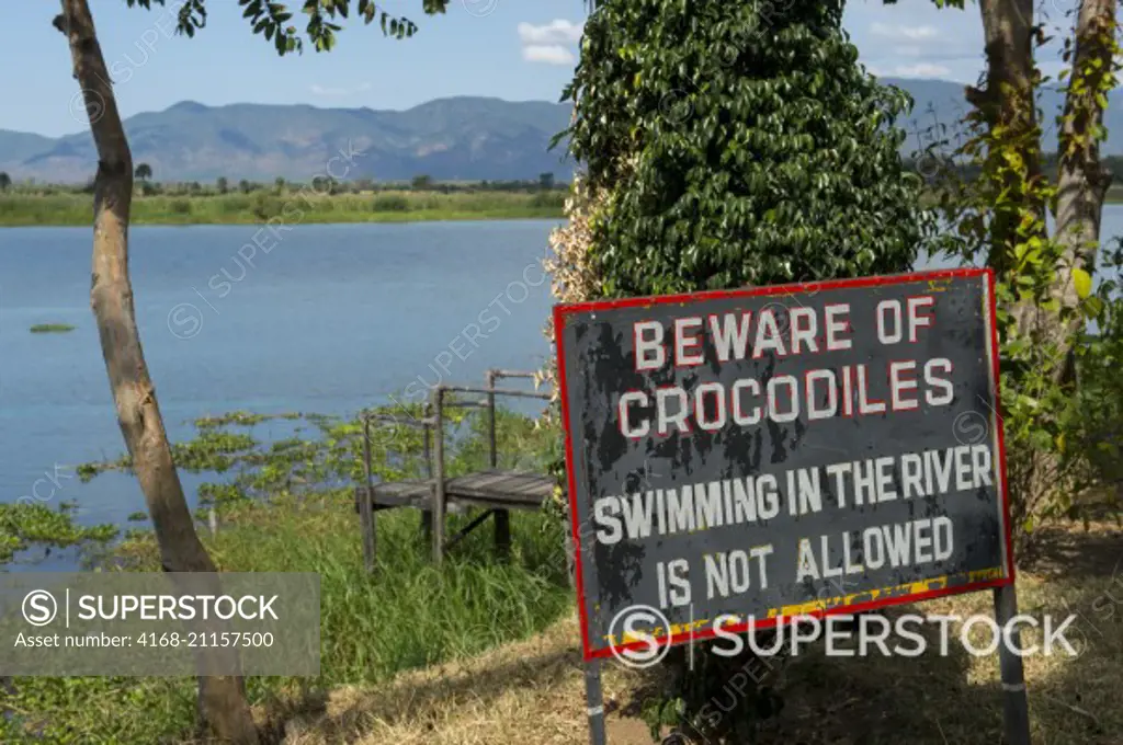 Be aware of the crocodiles sign on the bank of the Shire River in the small town of Liwonde, Southern Region, Malawi.