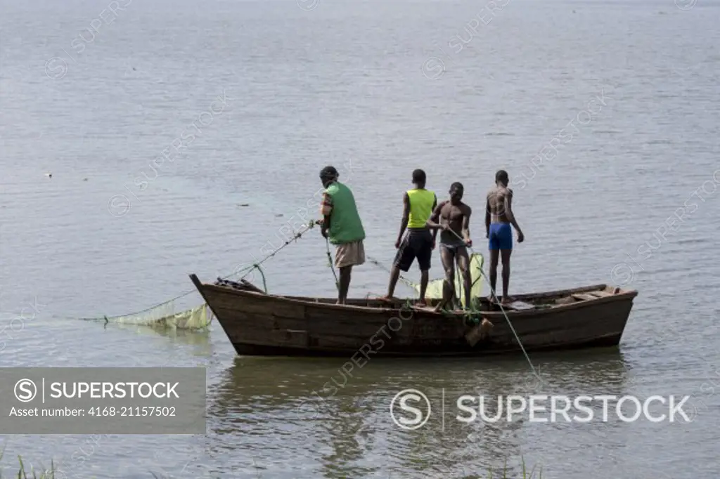 A group of fishermen is setting a net on the Shire River in the small town of Liwonde, Southern Region, Malawi.