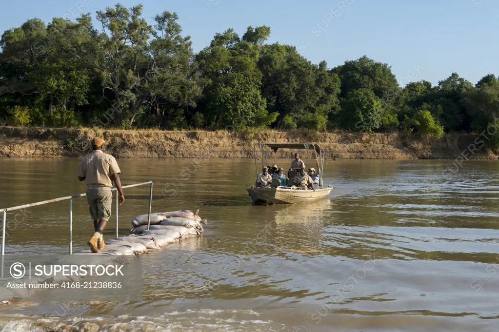A boat is crossing the Luangwa River from Nkwali Camp to the South Luangwa National Park in eastern Zambia.