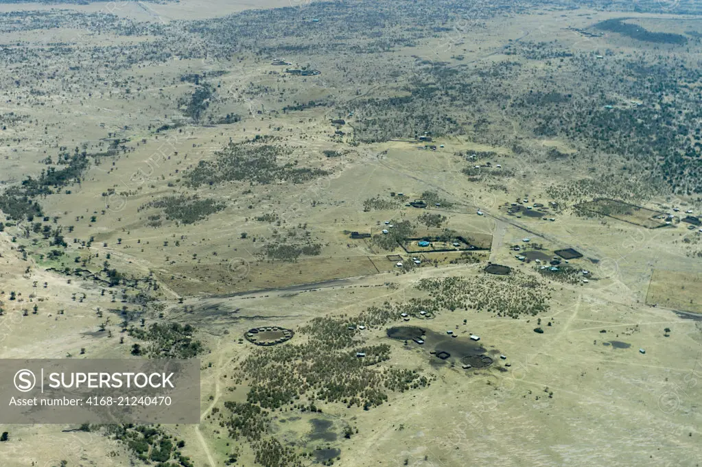 Aerial view of a Maasai village at the edge of the Masai Mara National Reserve in Kenya.