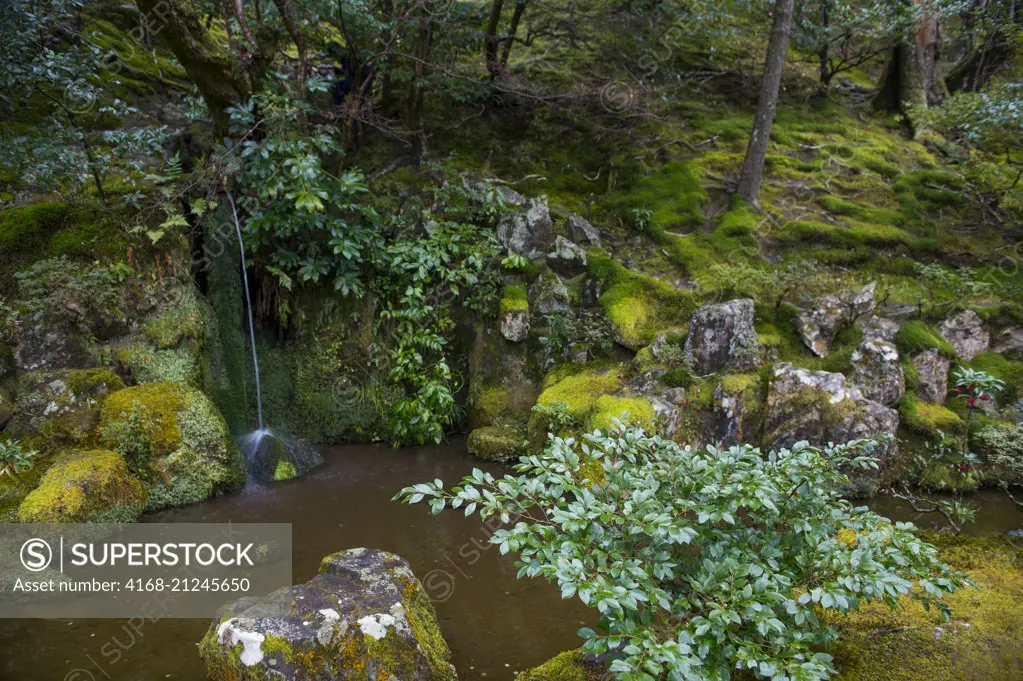 A small waterfall in the moss garden, part of the garden of the Ginkaku-ji or Temple of the Silver Pavilion (UNESCO World Heritage Site), a Zen temple in the Sakyo ward of Kyoto, Japan.