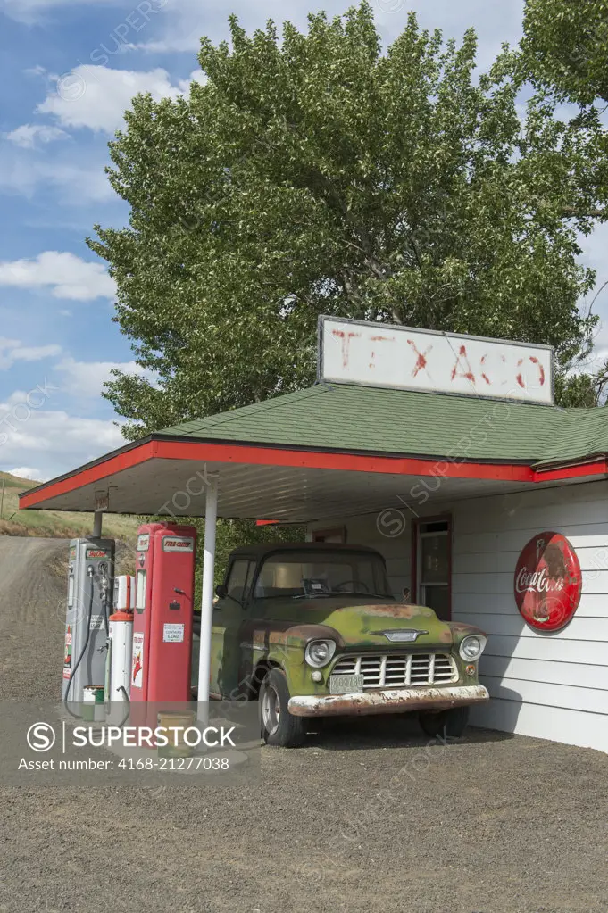 An old gas station with old car collection at a farm near Colfax in Whitman County in the Palouse, Washington State, USA.