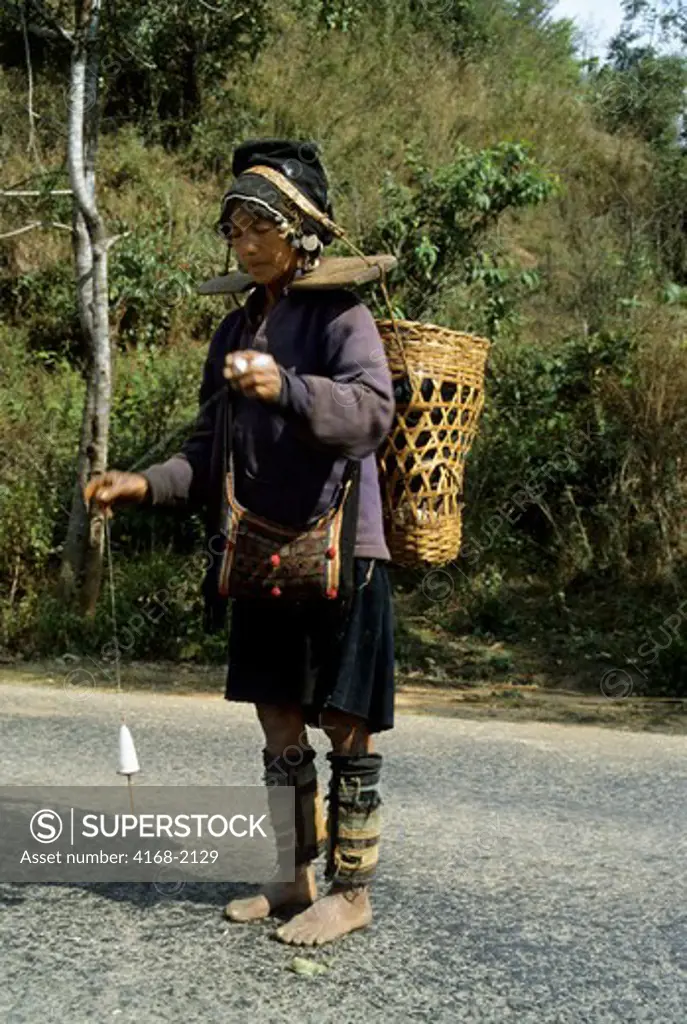 China, Yunan Province, Hani Woman Spinning Wool For Weaving, Xishuang Bana