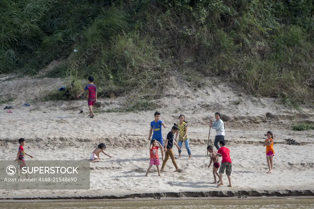 Children playing on the riverbank of the Mekong River near Luang Prabang in Central Laos.