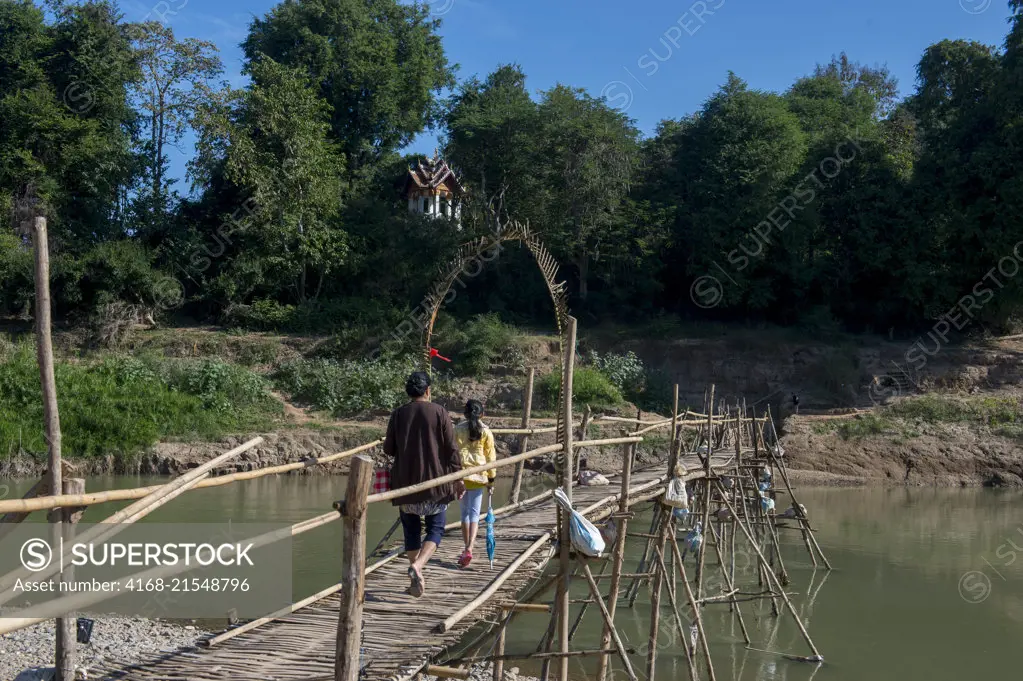 A bamboo bridge over the Nam Khan River near the confluence of the Nam Khan and Mekong Rivers at Luang Prabang in Central Laos.