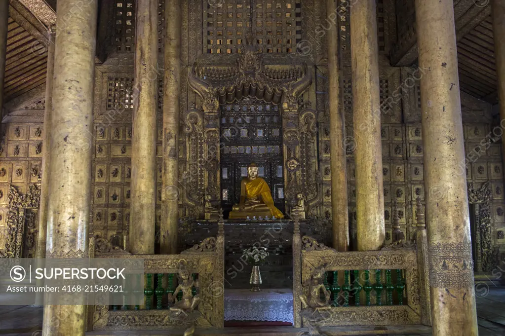 The interior with a Buddha statue of the Shwenandaw Monastery (Golden Palace Monastery) in Mandalay Hill, which was built in 1880 by King Thibaw Min with originally parts of the royal palace at Amarapura in Myanmar.