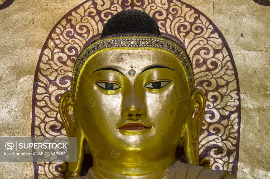 Close-up of one of the four Buddha statues inside the Ananda Temple, which is a Buddhist temple, built in 1105 AD during the reign (1084 to 1113) of King Kyanzittha of the Pagan Dynasty, in Bagan, Myanmar.