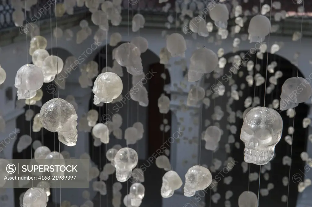 Glass skulls hanging on strings in the courtyard of the Museo de los Pintores Oaxaquenos in Oaxaca City, Mexico.
