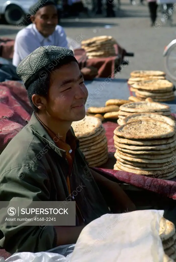 China, Xinjiang Province, Turfan, Market Scene, Uigur Boys Selling Bread