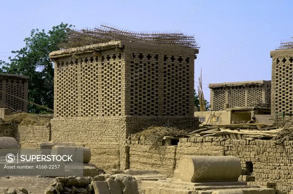 China, Xinjiang Province, Turfan, Moslem Cemetery With Grape Drying Buildings In Background