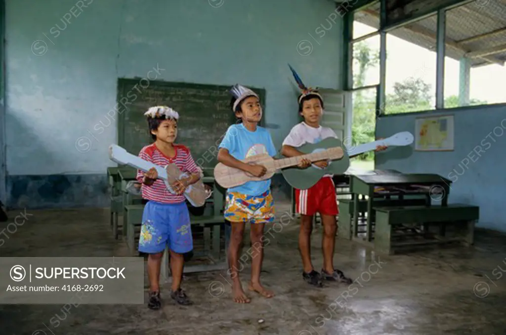 Ecuador, Amazon Basin, Near Coca, Rio Napo, School, Boys Sing With Make-Believe Guitars