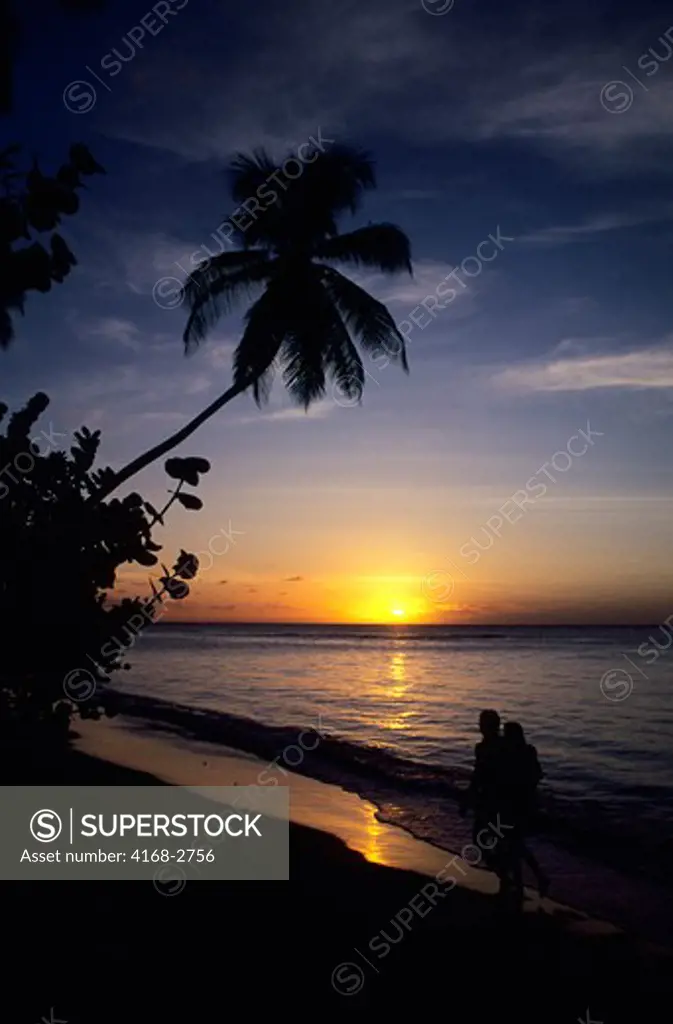 Tobago, Pigeon Point, Sunset With Couple Walking On Beach