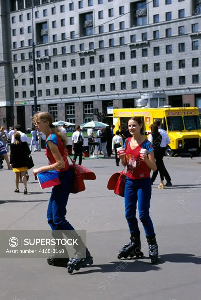 Russia, Moscow, Ploschad Revolyutsi Square, Girls On Rolling Skates Advertising Cigarettes