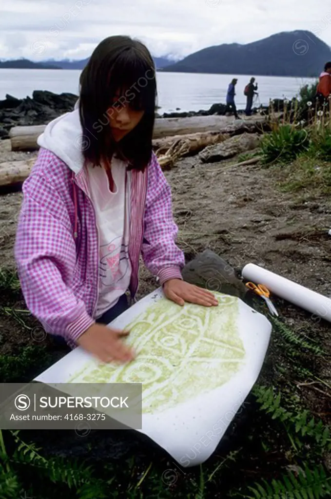 Usa, Alaska, Inside Passage, Wrangell Island, Petroglyph Beach,Local Girl Taking Rubbing Of Petroglyph