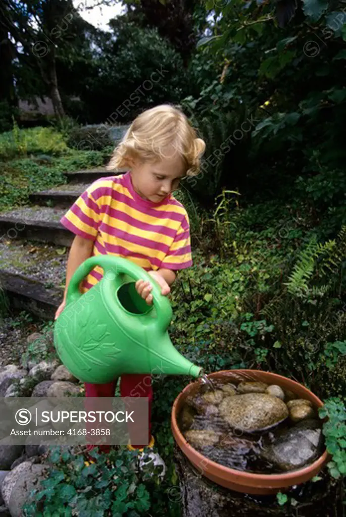 Usa, Washington, Bellevue, Girl,Filling Birdbath