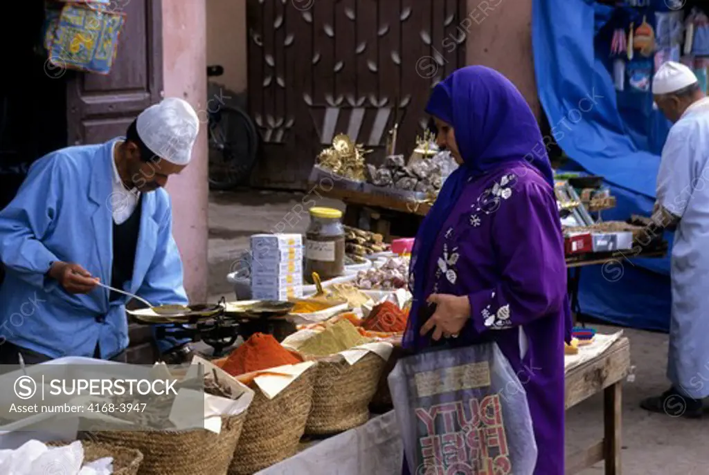 Morocco, Marrakech, Souk, Woman Buying Spices
